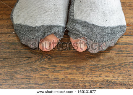 stock-photo-worn-out-socks-with-a-hole-and-toes-sticking-out-of-them-on-old-wooden-floor-160131677.jpg