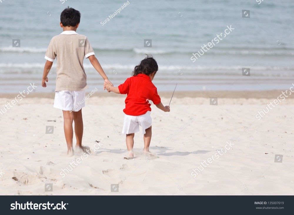 stock photo asian brothers holding hands on tropical beach 135007019