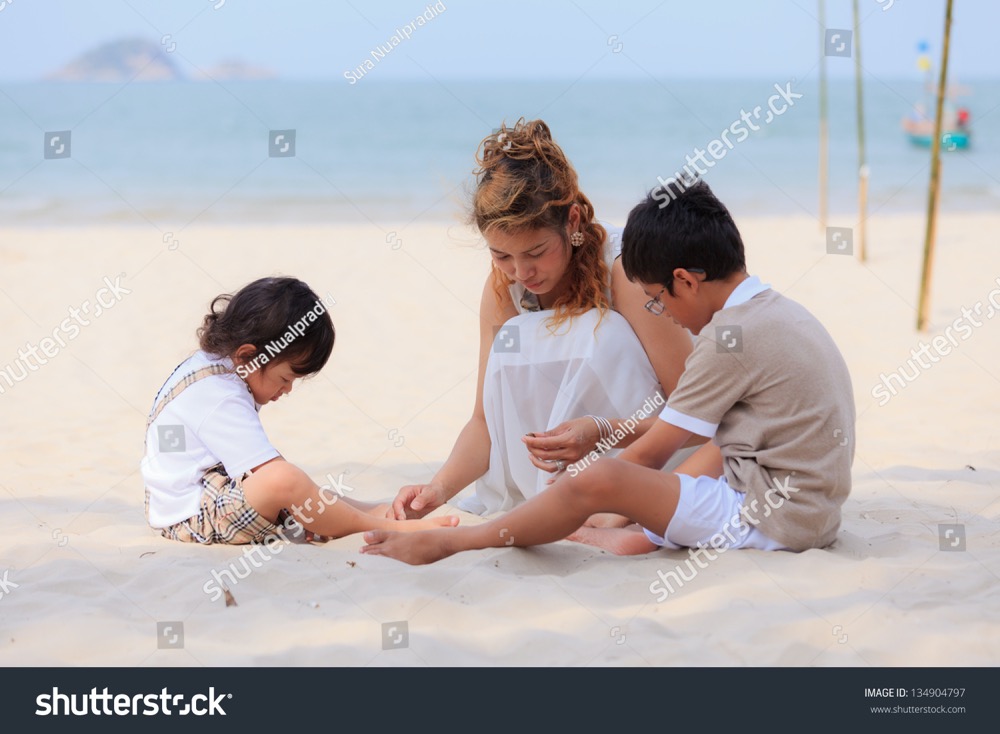 stock photo mom and sons playing on tropical beach 134904797