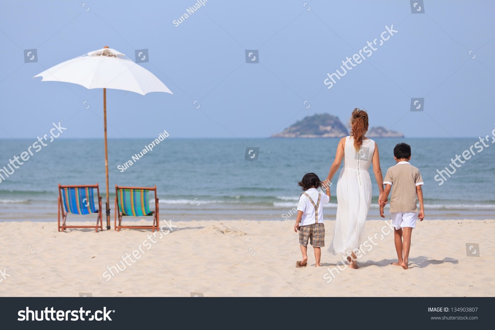 stock photo mother and sons walking on beach 134903807
