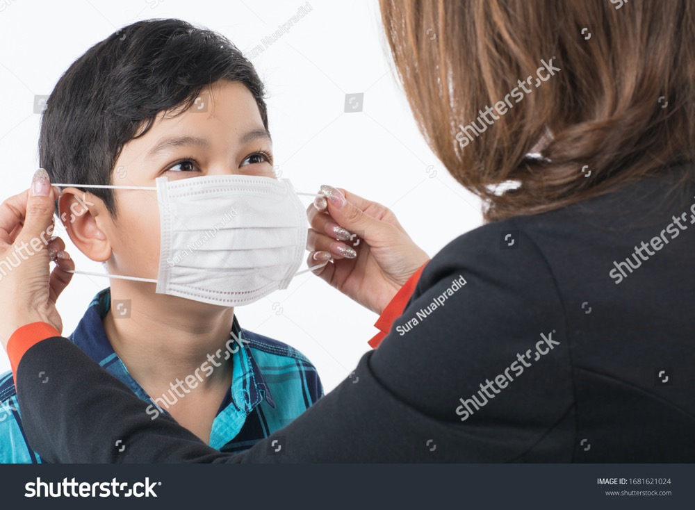 stock photo mother wearing surgical protective mask on face of son kid idea for love and care to prevent kid 1681621024